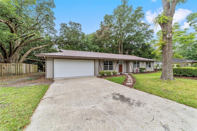 single story home with a front lawn and a garage