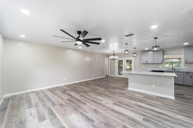 kitchen with a wealth of natural light, light wood-type flooring, and gray cabinetry