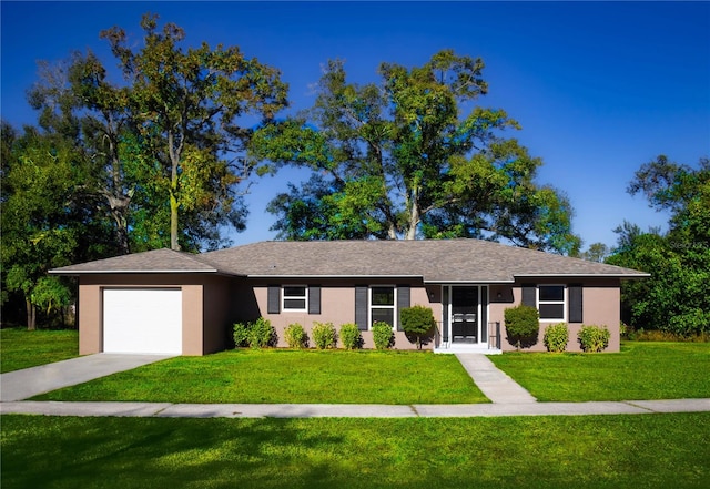 ranch-style house with a garage and a front lawn