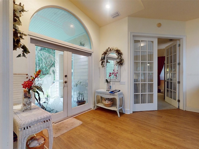 foyer entrance with light hardwood / wood-style flooring and french doors