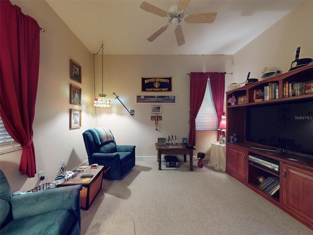 carpeted living room with ceiling fan