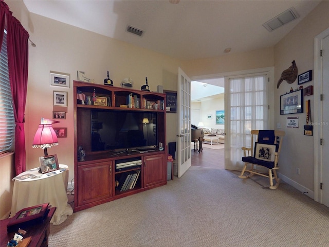 carpeted living room featuring french doors