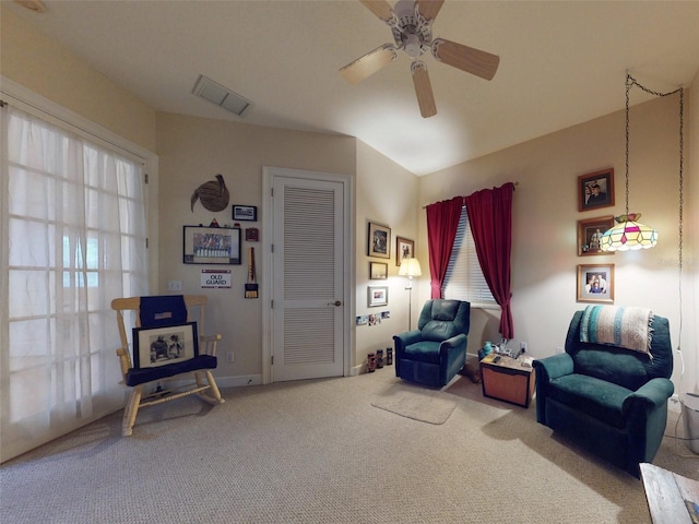 sitting room featuring carpet flooring, ceiling fan, and a healthy amount of sunlight