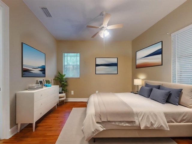 bedroom with ceiling fan and hardwood / wood-style flooring