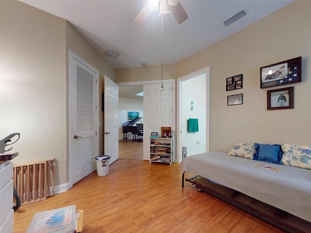 bedroom with light hardwood / wood-style floors and ceiling fan