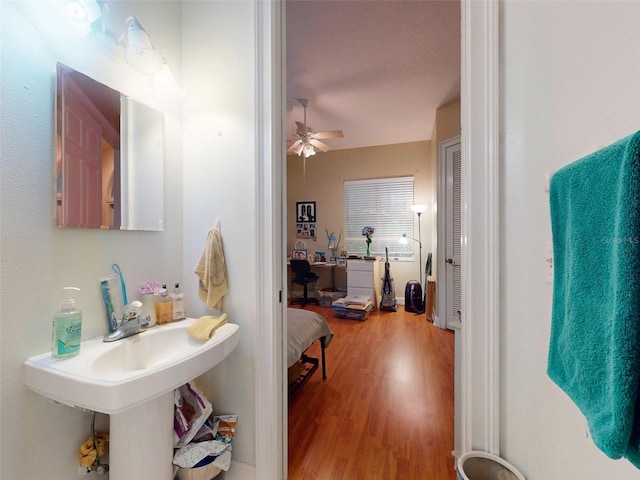 bathroom with hardwood / wood-style floors and ceiling fan