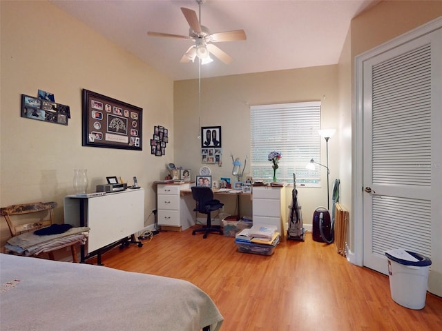 bedroom with light hardwood / wood-style floors and ceiling fan