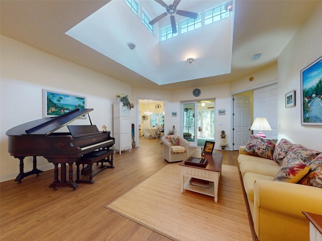 living room featuring light hardwood / wood-style floors and ceiling fan