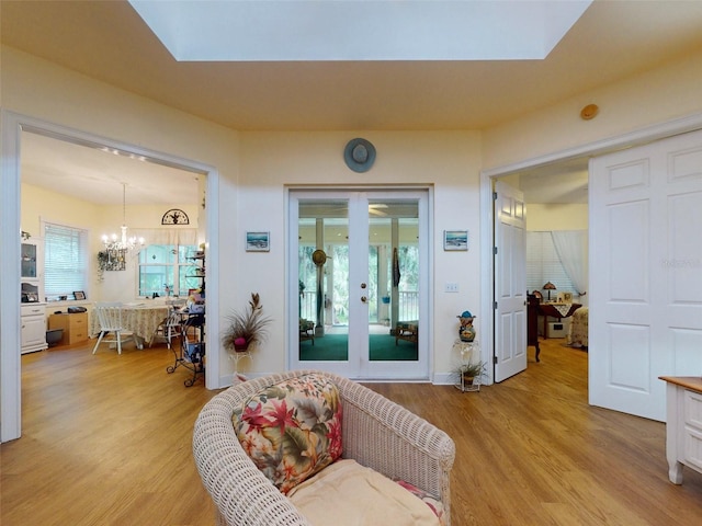 interior space featuring light hardwood / wood-style floors and an inviting chandelier