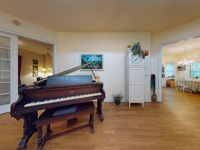 misc room with hardwood / wood-style flooring and a notable chandelier