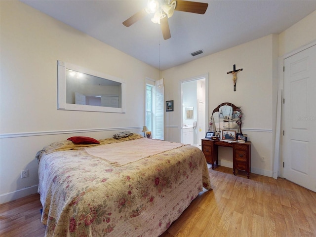 bedroom featuring light wood-type flooring, ensuite bathroom, and ceiling fan