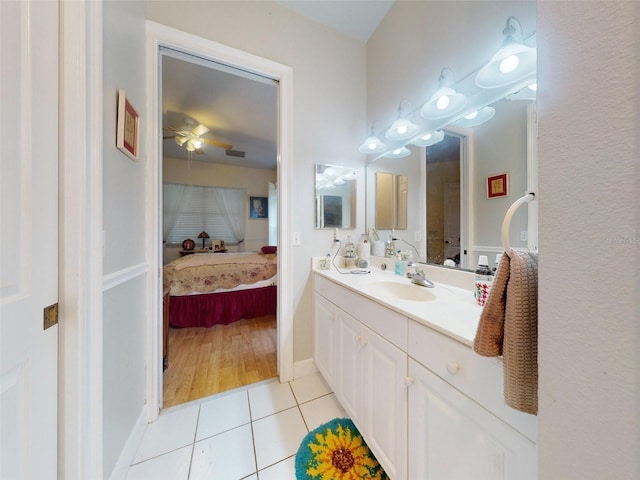 bathroom with ceiling fan, tile patterned flooring, and vanity