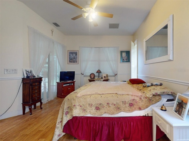 bedroom with ceiling fan and light hardwood / wood-style flooring