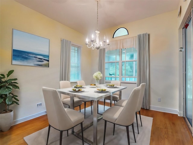 dining area featuring a chandelier and wood-type flooring