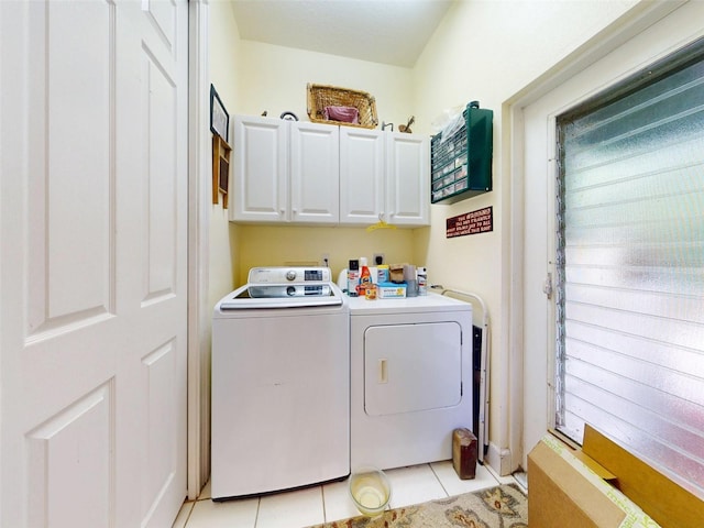 laundry room featuring cabinets, washing machine and dryer, and light tile patterned flooring