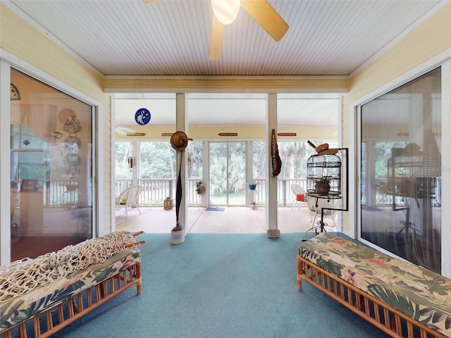 bedroom featuring access to exterior, ceiling fan, light colored carpet, and a closet