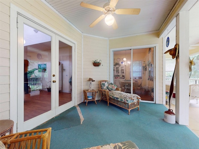 sunroom / solarium featuring ceiling fan and french doors