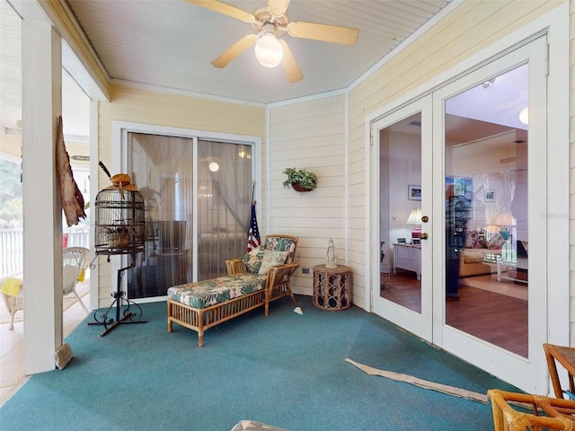 sunroom featuring ceiling fan