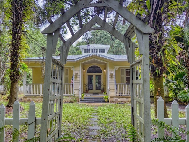 view of front of house with covered porch and french doors