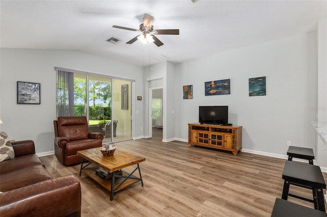 living room with lofted ceiling, wood-type flooring, and ceiling fan