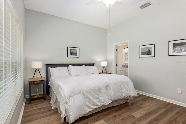 bedroom with connected bathroom, hardwood / wood-style floors, and ceiling fan