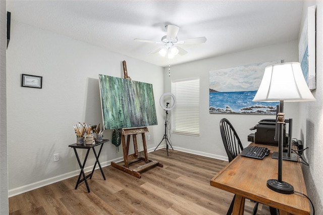 office area featuring wood-type flooring and ceiling fan