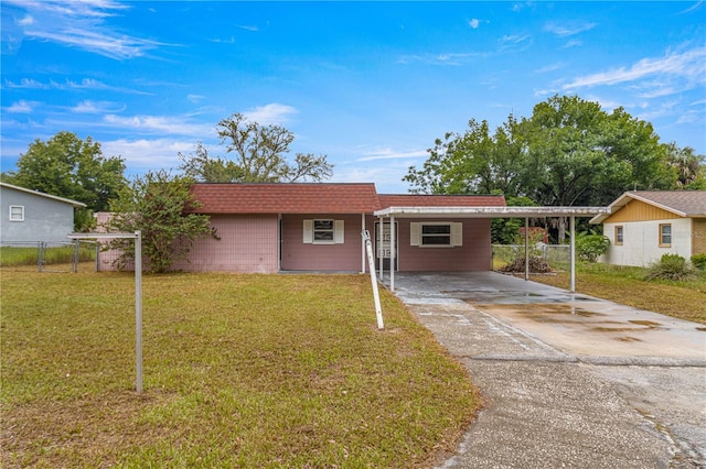 ranch-style house featuring a carport and a front yard