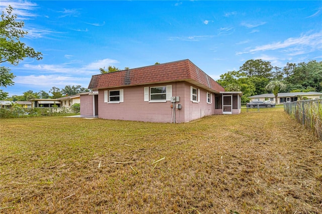 view of side of home with a lawn