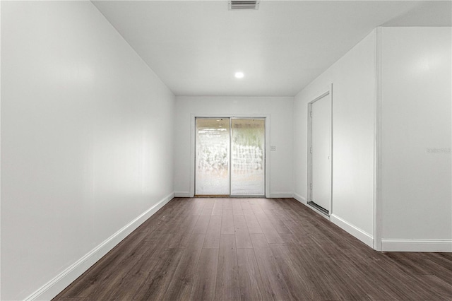 spare room featuring dark wood-type flooring