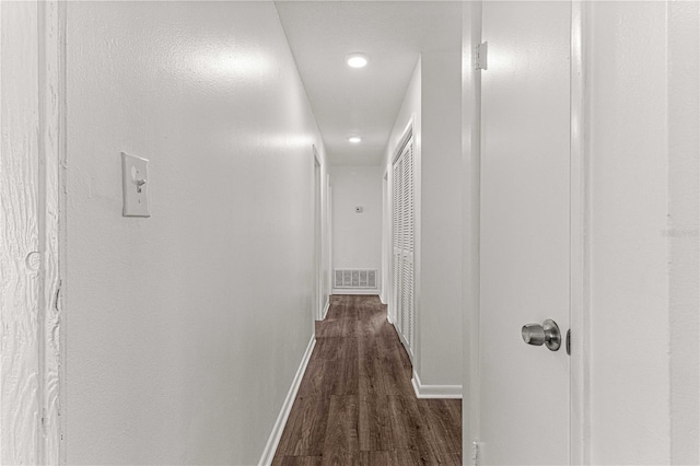 corridor featuring dark hardwood / wood-style floors