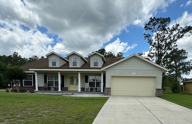 view of front of property featuring a garage, a front yard, and covered porch