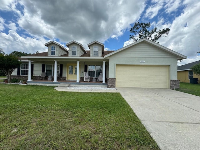 view of front of property featuring a front lawn, a garage, and a porch