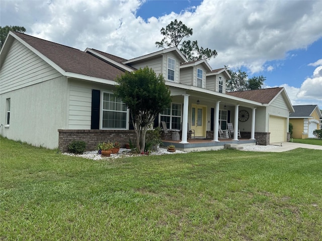 view of front facade with a garage, a front yard, and covered porch