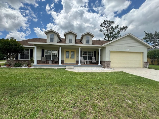 view of front of property with a garage, a front yard, and a porch