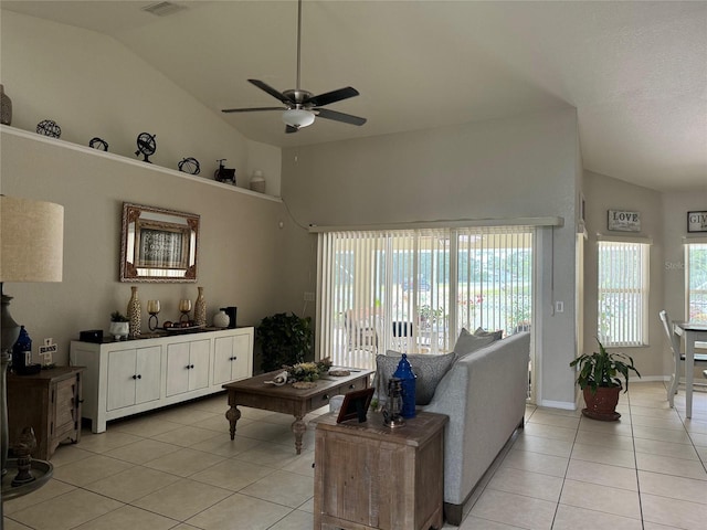 living room featuring high vaulted ceiling, light tile flooring, and ceiling fan