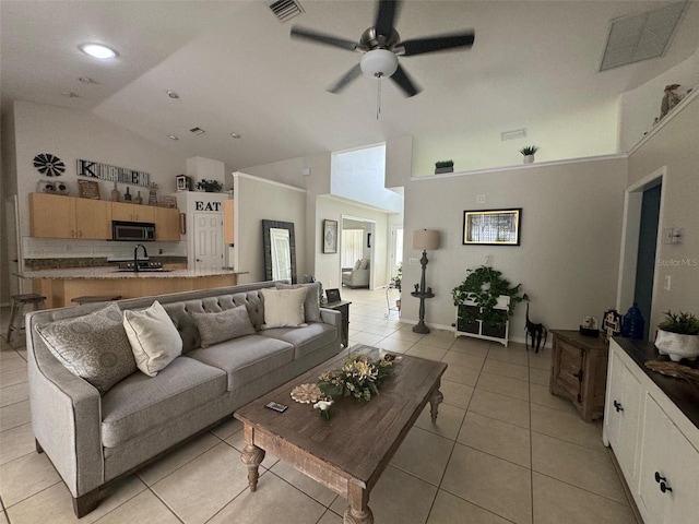 living room with high vaulted ceiling, sink, ceiling fan, and light tile floors