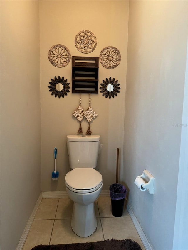 bathroom featuring tile flooring and toilet