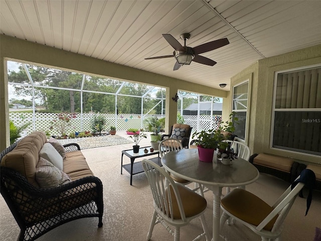 sunroom / solarium featuring plenty of natural light and ceiling fan