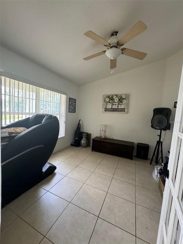 living room with light tile flooring and ceiling fan