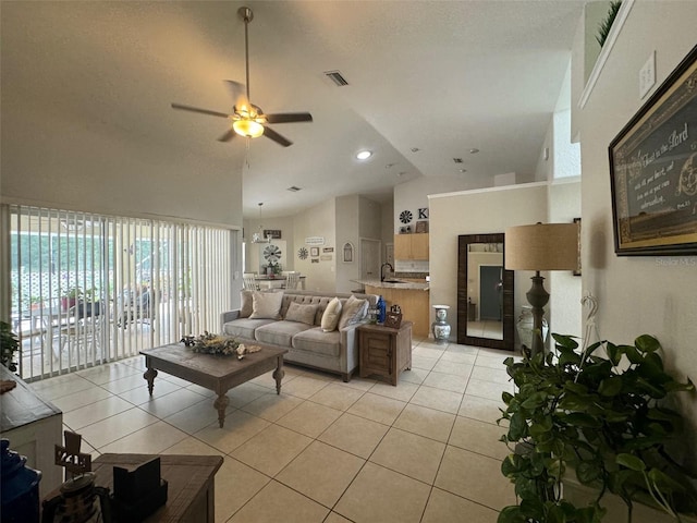 tiled living room featuring high vaulted ceiling, ceiling fan, a textured ceiling, and sink