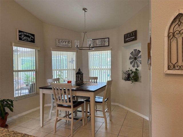 dining space featuring light tile floors