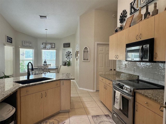 kitchen featuring light brown cabinetry, light tile floors, sink, stone countertops, and appliances with stainless steel finishes