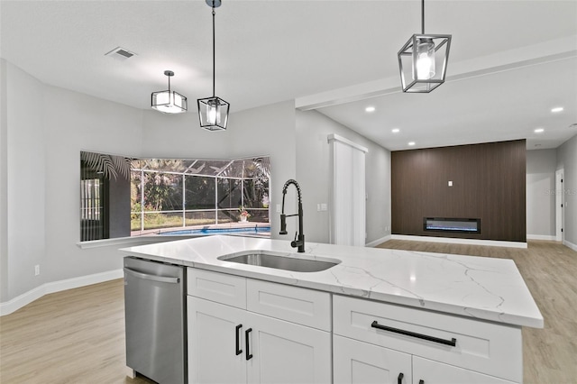 kitchen featuring light hardwood / wood-style flooring, white cabinetry, stainless steel dishwasher, and sink