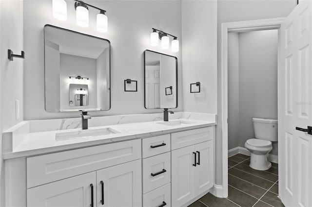 bathroom featuring tile patterned floors, vanity, and toilet