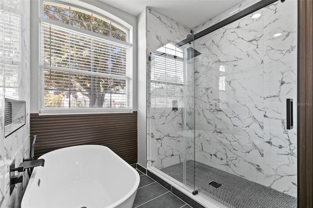 bathroom featuring tile patterned floors and independent shower and bath