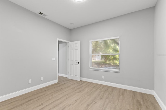 spare room with light wood-type flooring