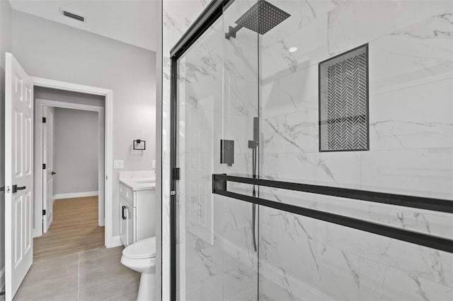 bathroom with vanity, hardwood / wood-style flooring, toilet, and a shower with door