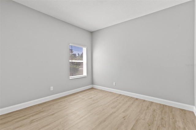 spare room with light hardwood / wood-style floors