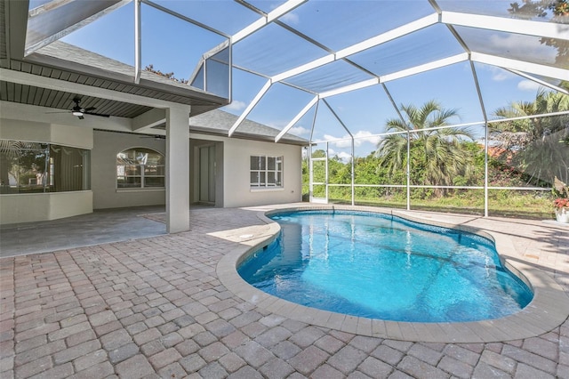 view of pool with a lanai, a patio area, and ceiling fan