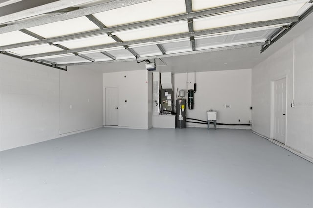 garage with electric water heater and a garage door opener